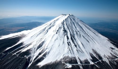 man climbs mt. fuji in the winter